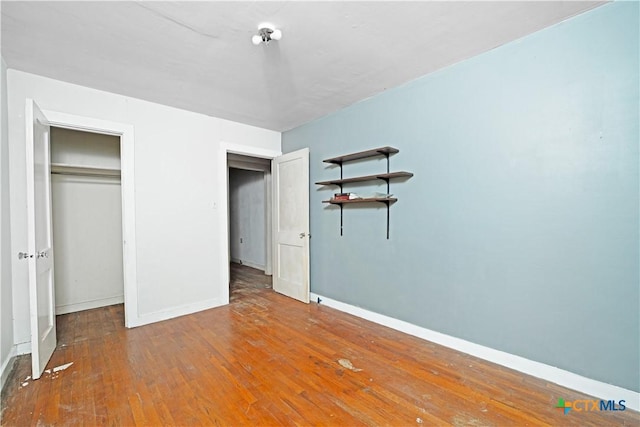 2021 Chinaberry Ln, New Braunfels, TX 78130 - unfurnished bedroom featuring wood-type flooring and baseboards