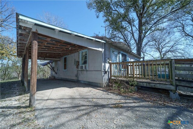 2021 Chinaberry Ln, New Braunfels, TX 78130 - view of side of property featuring an attached carport, a deck, driveway, and cooling unit