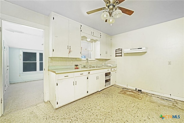 2021 Chinaberry Ln, New Braunfels, TX 78130 - kitchen featuring backsplash, light countertops, a ceiling fan, and white cabinetry