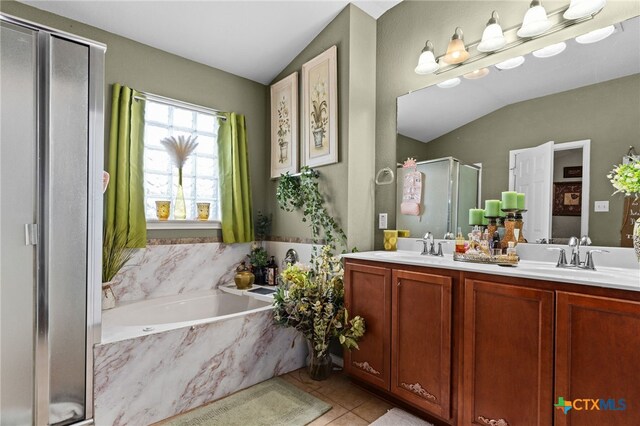 2307 Scott Dr, Copperas Cove, TX 76522 - bathroom featuring a shower stall, vaulted ceiling, a bath, double vanity, and tile patterned flooring