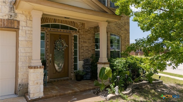 2307 Scott Dr, Copperas Cove, TX 76522 - view of exterior entry featuring stone siding, brick siding, and covered porch