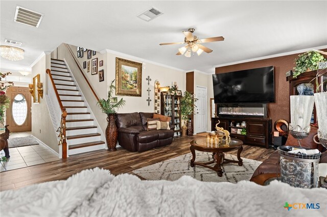 2307 Scott Dr, Copperas Cove, TX 76522 - living area featuring wood finished floors, ornamental molding, stairway, ceiling fan, and baseboards