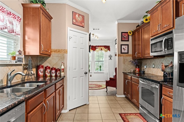 2307 Scott Dr, Copperas Cove, TX 76522 - kitchen with appliances with stainless steel finishes, a sink, light tile patterned floors, ornamental molding, and decorative backsplash