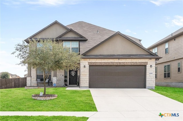 view of front of home with an attached garage, driveway, a front lawn, and stucco siding