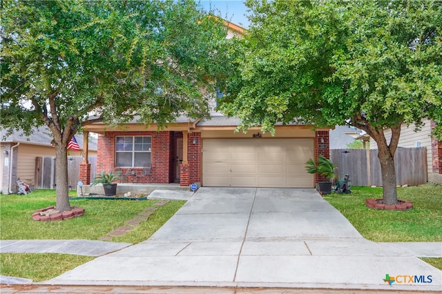 view of front of property featuring a garage and a front lawn