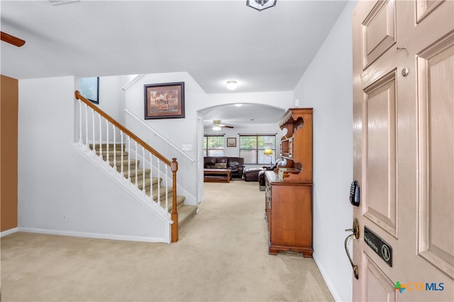 carpeted foyer with ceiling fan