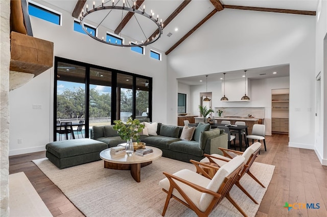 living room with beam ceiling, high vaulted ceiling, an inviting chandelier, and wood-type flooring