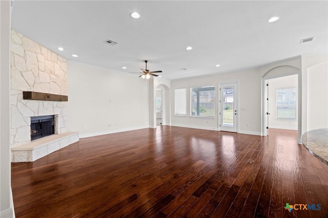 200 Tate Ln, Round Rock, TX 78626 - unfurnished living room with hardwood / wood-style flooring, a fireplace, ceiling fan, arched walkways, and recessed lighting