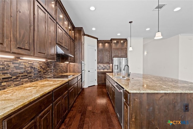 200 Tate Ln, Round Rock, TX 78626 - kitchen featuring under cabinet range hood, appliances with stainless steel finishes, dark wood-type flooring, dark brown cabinetry, and recessed lighting