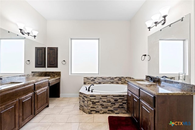 200 Tate Ln, Round Rock, TX 78626 - bathroom with two vanities, a garden tub, and tile patterned floors