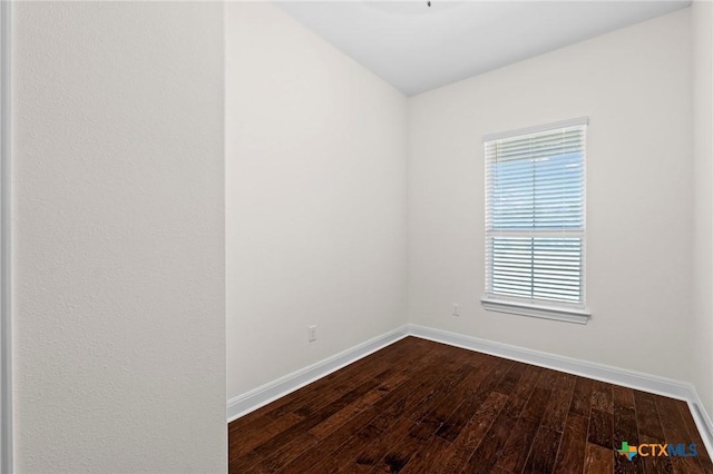 200 Tate Ln, Round Rock, TX 78626 - unfurnished room with baseboards and dark wood-type flooring