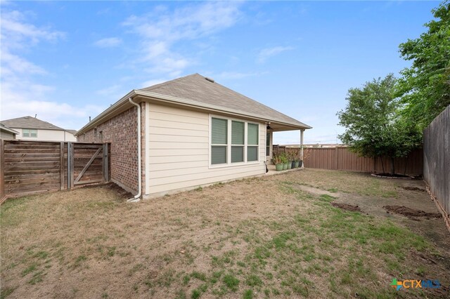 14000 Alloro Dr, Austin, TX 78717 - exterior space featuring a yard, a fenced backyard, a gate, and brick siding