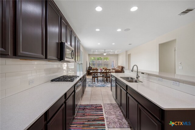 14000 Alloro Dr, Austin, TX 78717 - kitchen with recessed lighting, appliances with stainless steel finishes, light countertops, a sink, and decorative backsplash