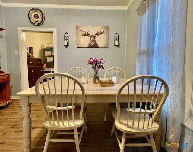 dining room featuring crown molding and wood finished floors