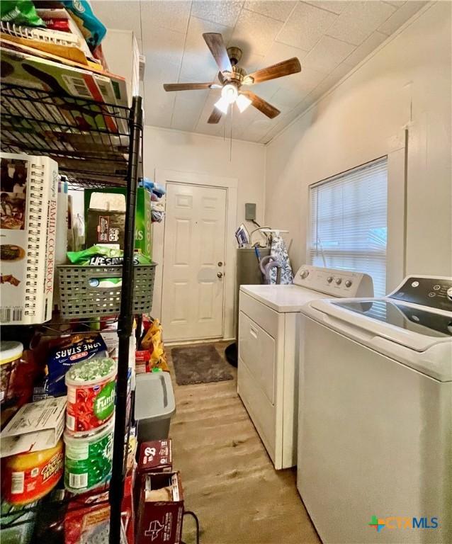 washroom with a ceiling fan, laundry area, light wood finished floors, and separate washer and dryer