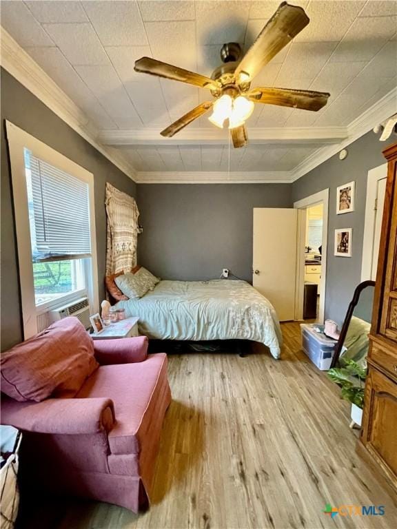 bedroom featuring light wood-style floors, ceiling fan, and crown molding