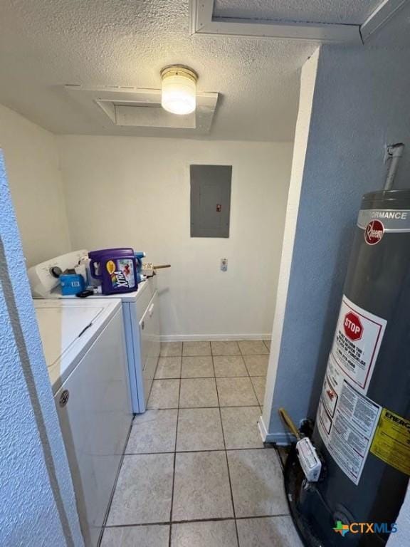 laundry area with water heater, light tile patterned floors, a textured ceiling, washing machine and dryer, and electric panel