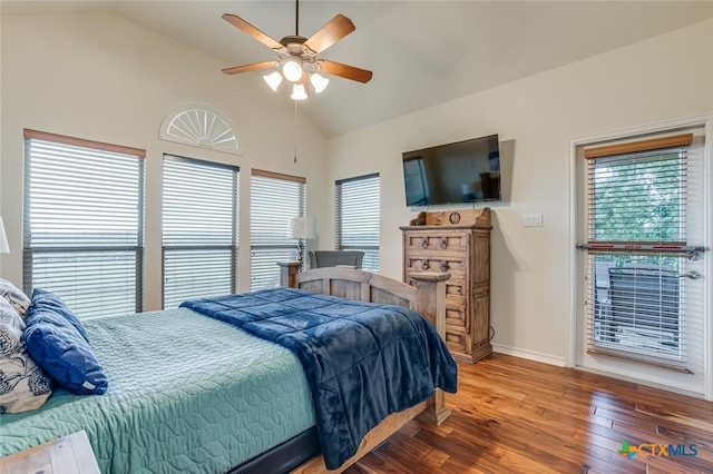 bedroom with multiple windows, wood-type flooring, and vaulted ceiling