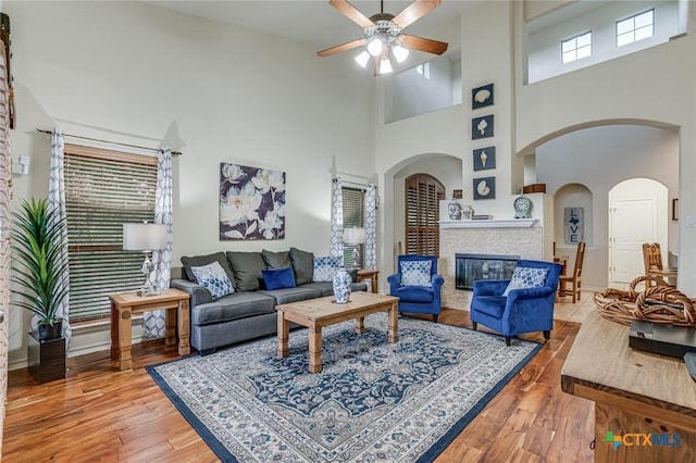 living room featuring hardwood / wood-style flooring and ceiling fan