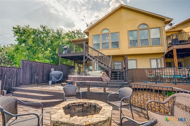 deck with a grill and a fire pit