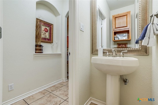 bathroom with tile patterned flooring and sink