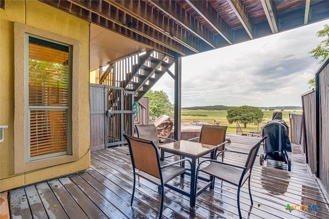 wooden deck with a rural view