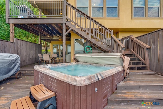 wooden deck featuring a hot tub and area for grilling