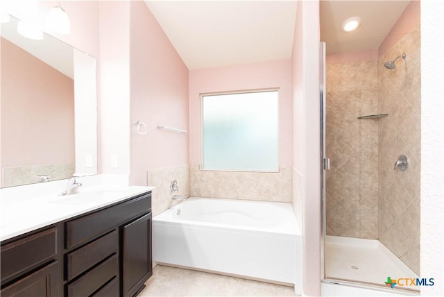 bathroom featuring a shower stall, a garden tub, and vanity