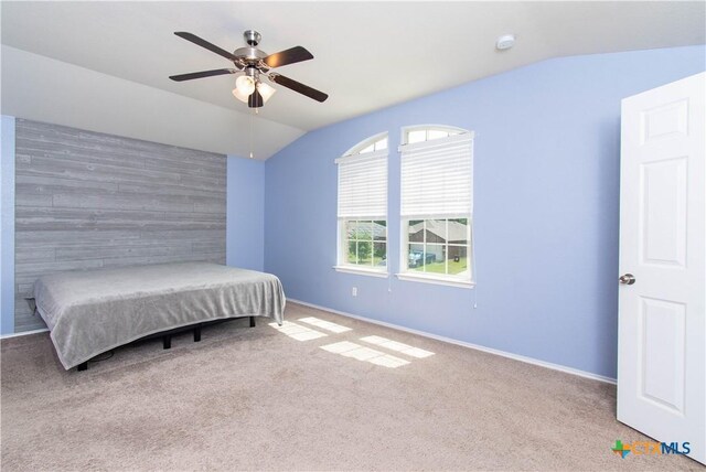 carpeted bedroom featuring baseboards, a ceiling fan, and vaulted ceiling