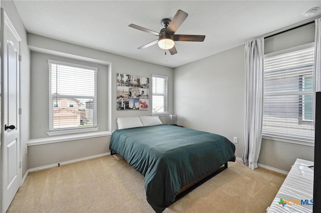 6309 Carriage Pines Dr, Del Valle, TX 78617 - bedroom featuring baseboards, ceiling fan, multiple windows, and carpet