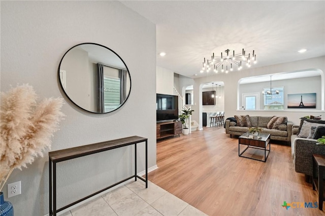 6309 Carriage Pines Dr, Del Valle, TX 78617 - living area with recessed lighting, a chandelier, baseboards, arched walkways, and wood finished floors