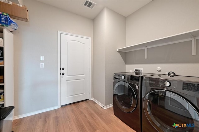6309 Carriage Pines Dr, Del Valle, TX 78617 - laundry area with independent washer and dryer, light wood-style flooring, visible vents, baseboards, and laundry area