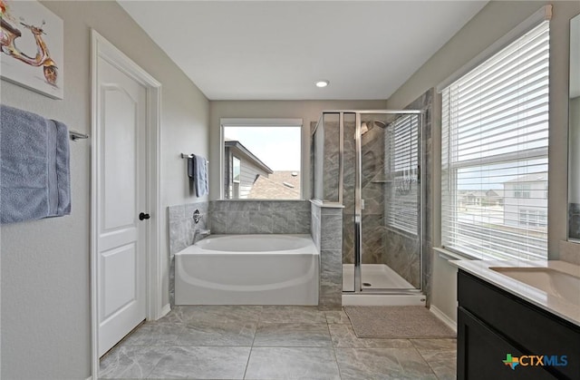 6309 Carriage Pines Dr, Del Valle, TX 78617 - bathroom with a healthy amount of sunlight, a shower stall, a garden tub, and vanity