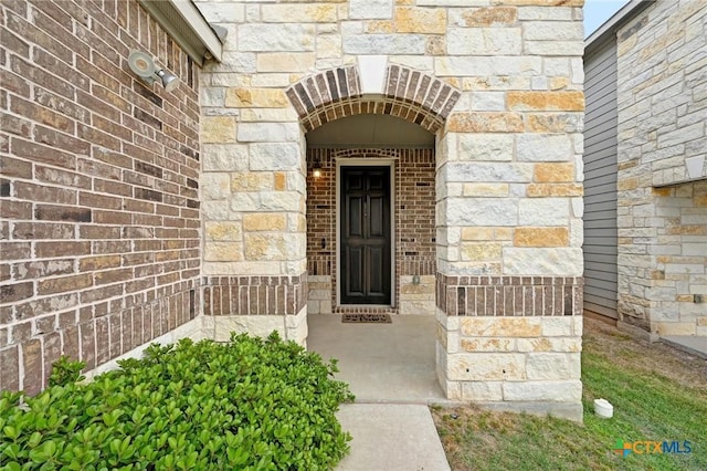 6309 Carriage Pines Dr, Del Valle, TX 78617 - doorway to property featuring brick siding and stone siding