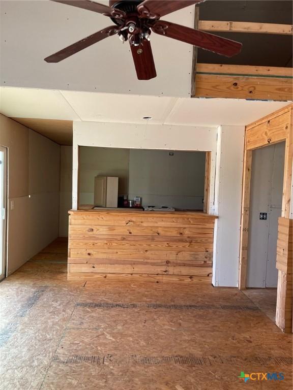 2413 Fuller Dr, Canyon Lake, TX 78133 - unfurnished living room featuring a ceiling fan