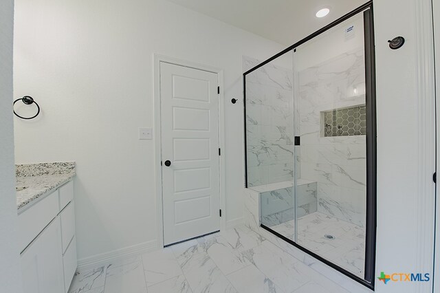 bathroom featuring vanity and an enclosed shower