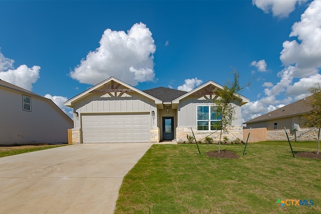 view of front of home with a garage and a front yard