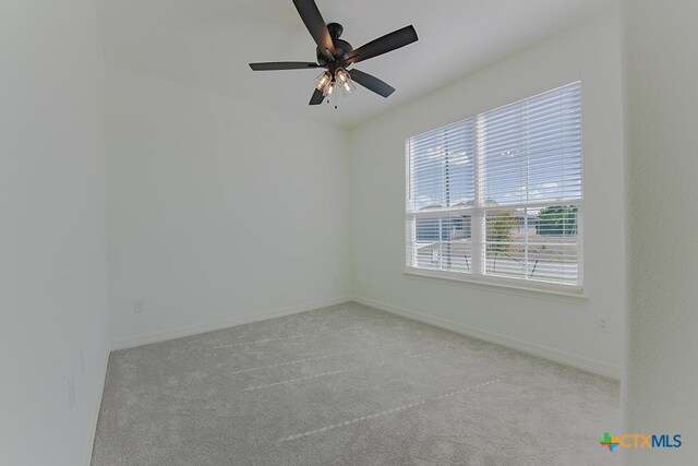 carpeted spare room with ceiling fan