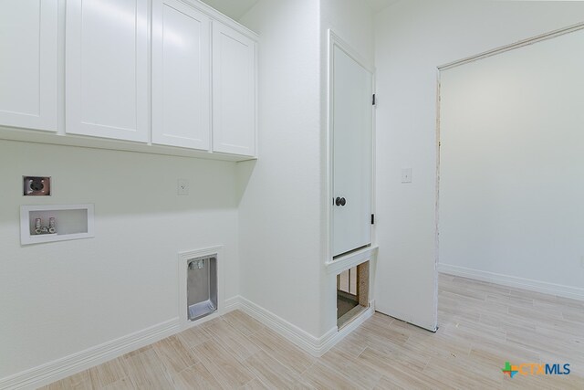 washroom featuring light hardwood / wood-style flooring, washer hookup, cabinets, and hookup for an electric dryer