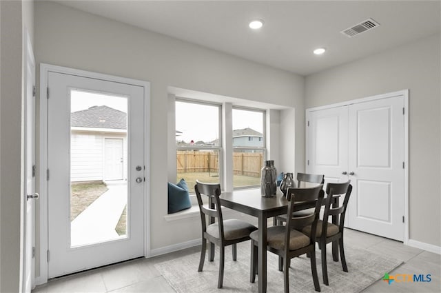 tiled dining room featuring a wealth of natural light