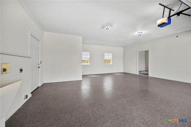 34 Spruce Dr, Belton, TX 76513 - garage featuring a garage door opener and baseboards