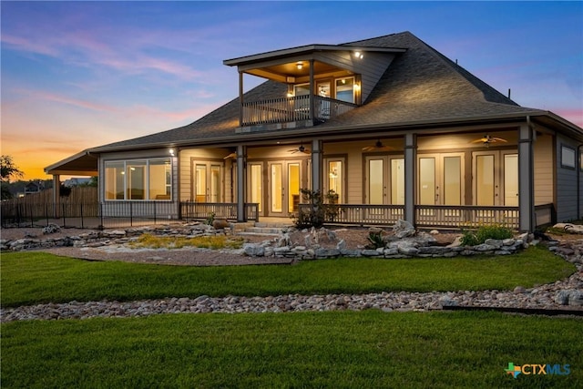 34 Spruce Dr, Belton, TX 76513 - back of property at dusk featuring a balcony, ceiling fan, roof with shingles, and a patio area