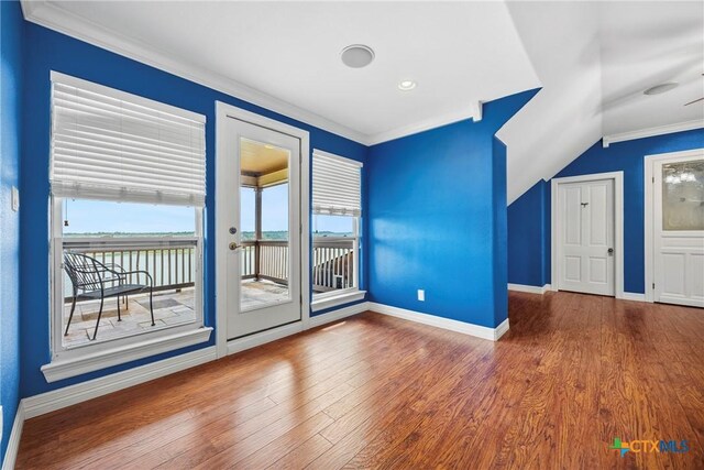 34 Spruce Dr, Belton, TX 76513 - unfurnished room with baseboards, ornamental molding, wood finished floors, vaulted ceiling, and a water view
