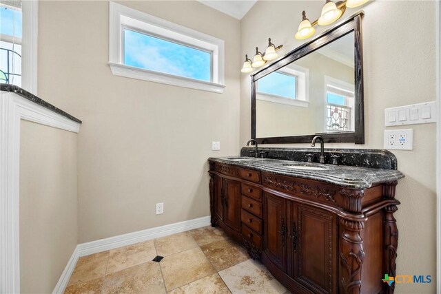 34 Spruce Dr, Belton, TX 76513 - bathroom with healthy amount of natural light, double vanity, and baseboards