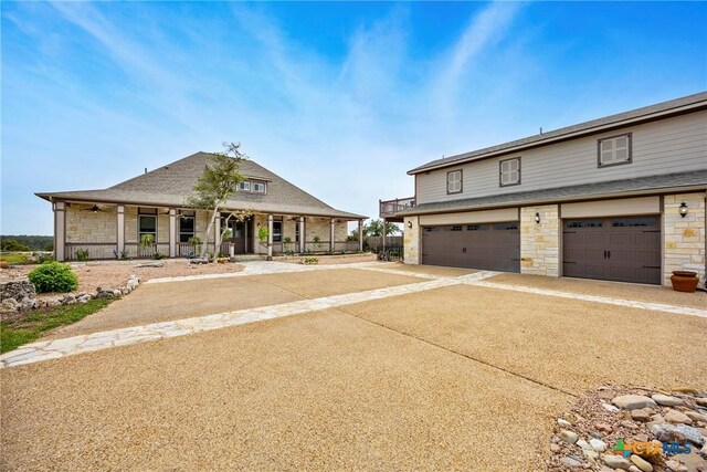 34 Spruce Dr, Belton, TX 76513 - view of front of property with stone siding, an attached garage, concrete driveway, and a porch