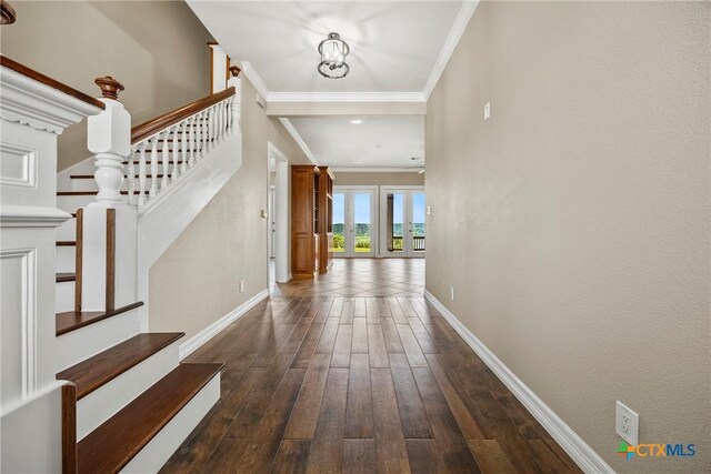 34 Spruce Dr, Belton, TX 76513 - entrance foyer with baseboards, stairway, crown molding, dark wood-style flooring, and a chandelier