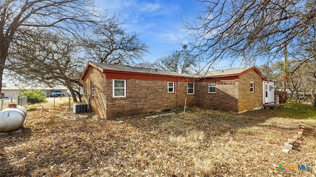 rear view of property featuring central air condition unit