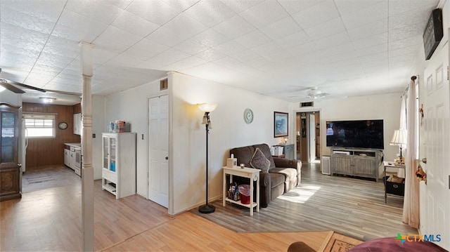 living room featuring ceiling fan and light hardwood / wood-style floors