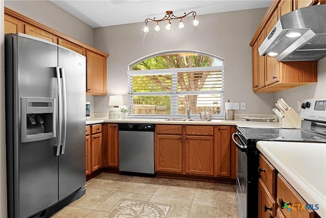 kitchen featuring brown cabinetry, appliances with stainless steel finishes, light countertops, under cabinet range hood, and a sink