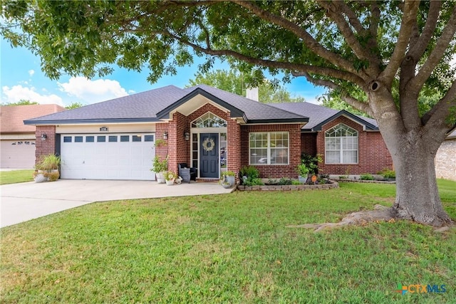 ranch-style home featuring concrete driveway, a chimney, an attached garage, a front lawn, and brick siding